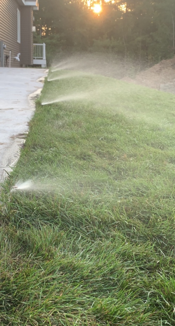 Residential sprinkler system watering a lawn